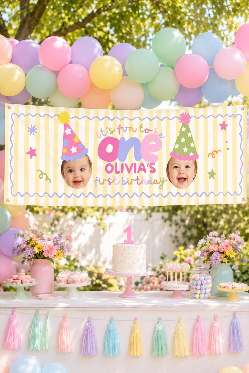 Fun to Be One first birthday backdrop with yellow stripes, blue wavy border and baby photo party hats