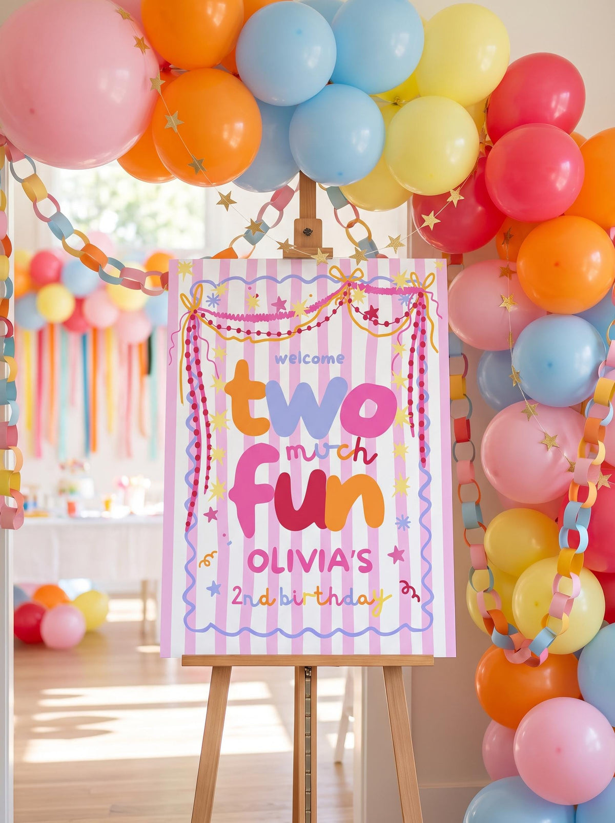 Colorful Two Much Fun second birthday welcome sign displayed at a girls party